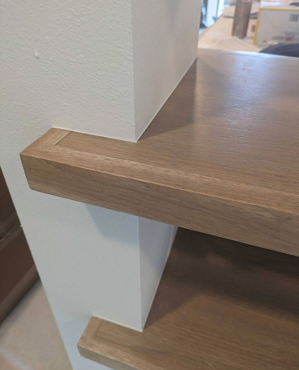 Painted wall around wood utility shelves